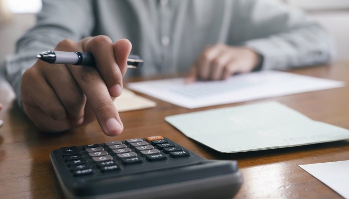 Closeup accountant using calculator